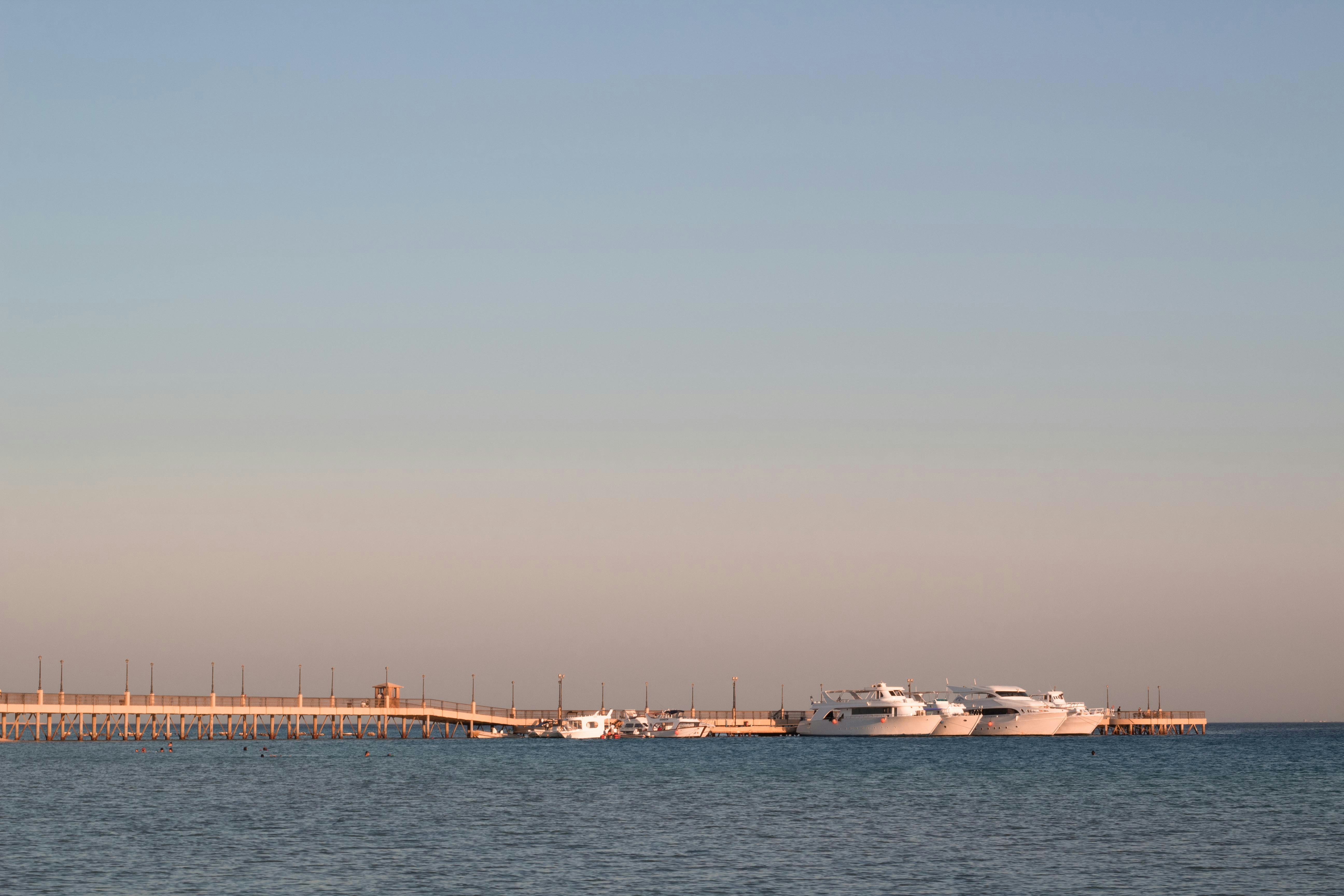 white boat on sea during daytime